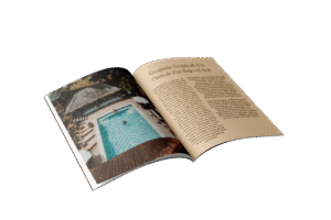 Revista abierta con artículo sobre un oasis tropical y piscina, en un entorno natural y relajante.