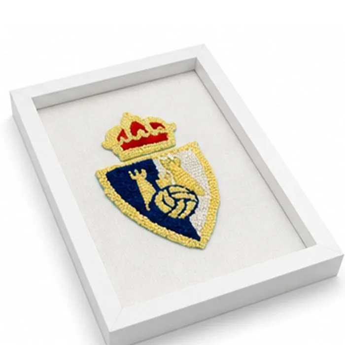 Detalle del escudo bordado a mano del club SDP